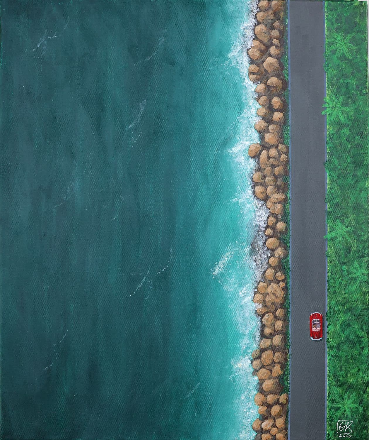 A bird's eye view of the coast, with a red Porsche on the road