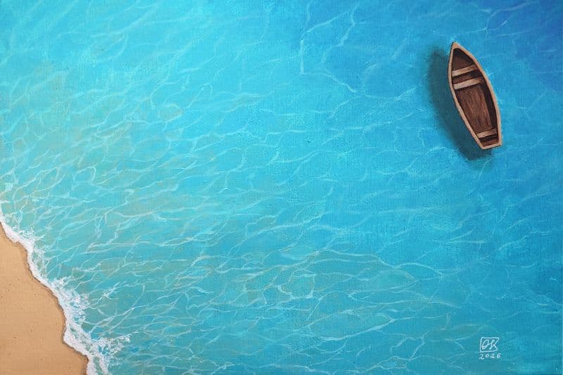 A boat on turquoise water seen from above